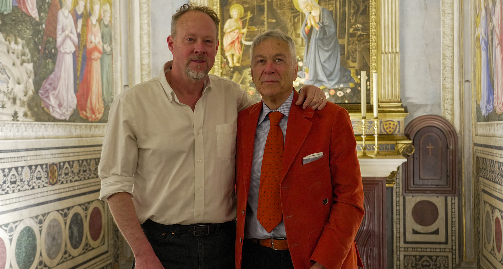 Professor George Bent and Ricciardo Artusi stand in the Magi Chapel of the Palazzo Medici Riccardi where the walls are covered in frescoes depicting the Journey of the Magi by Renaissance master Benozzo Gozzoli.